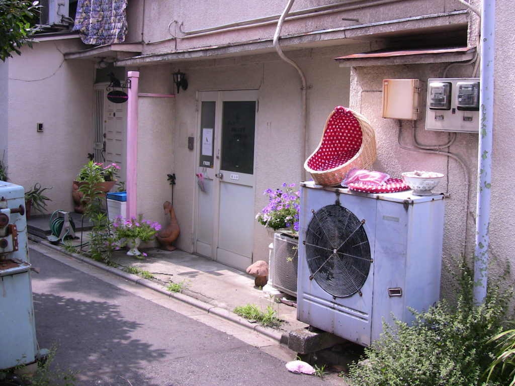Backside of a house, large air conditioning unit