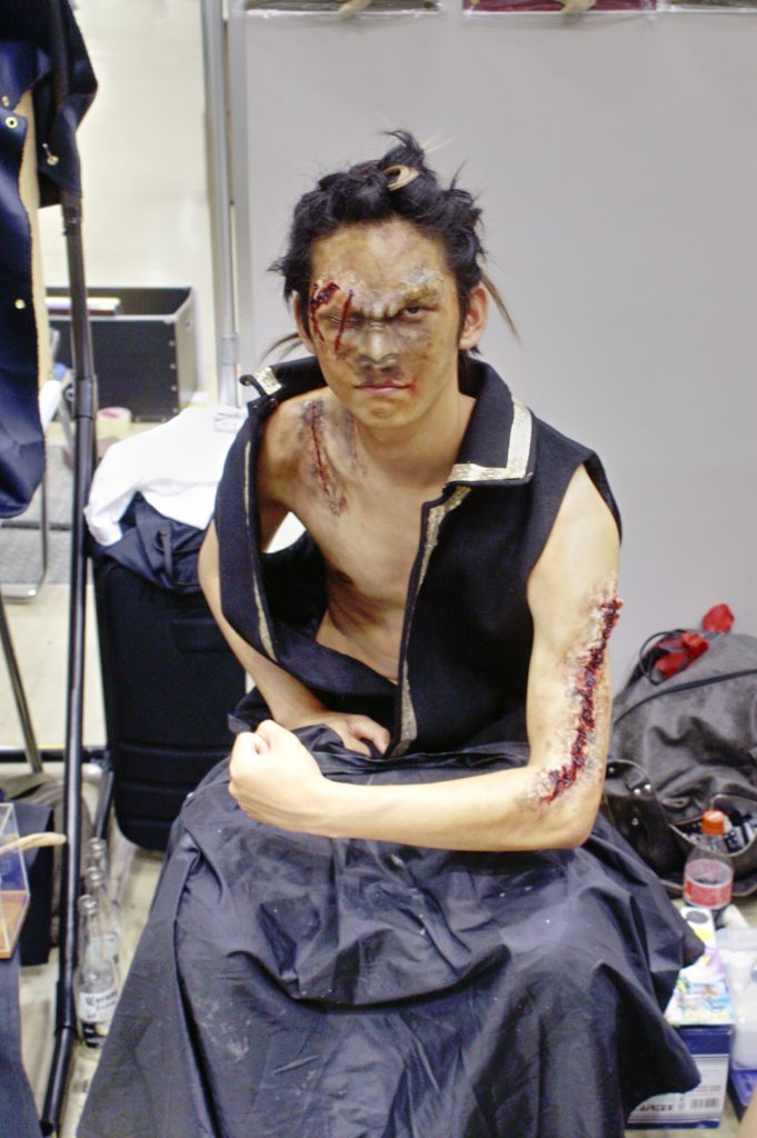 Design Festa 25: Japanese guy in tough pose with deep wounds (makeup)