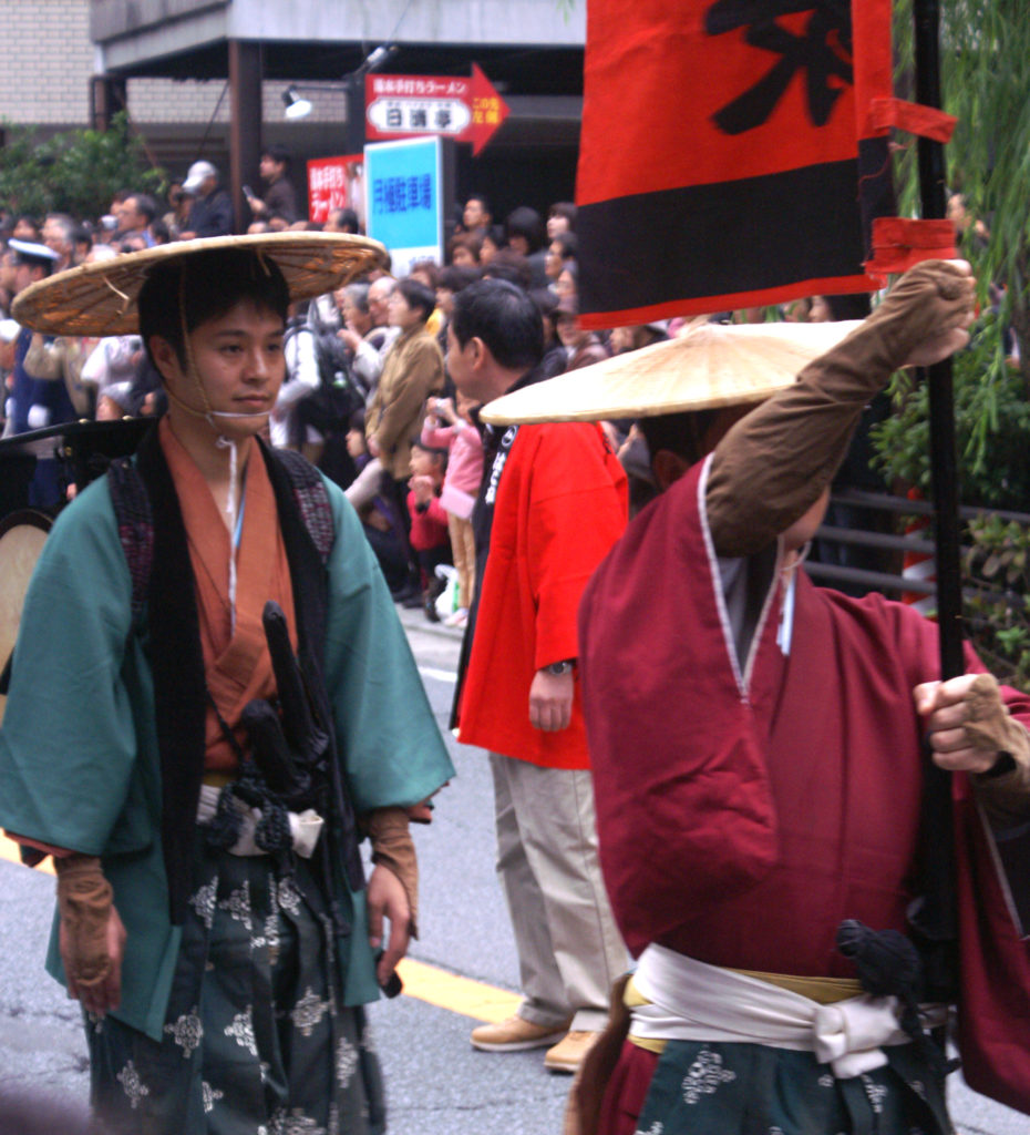Japanese dressed in traditional clothes at a parade
