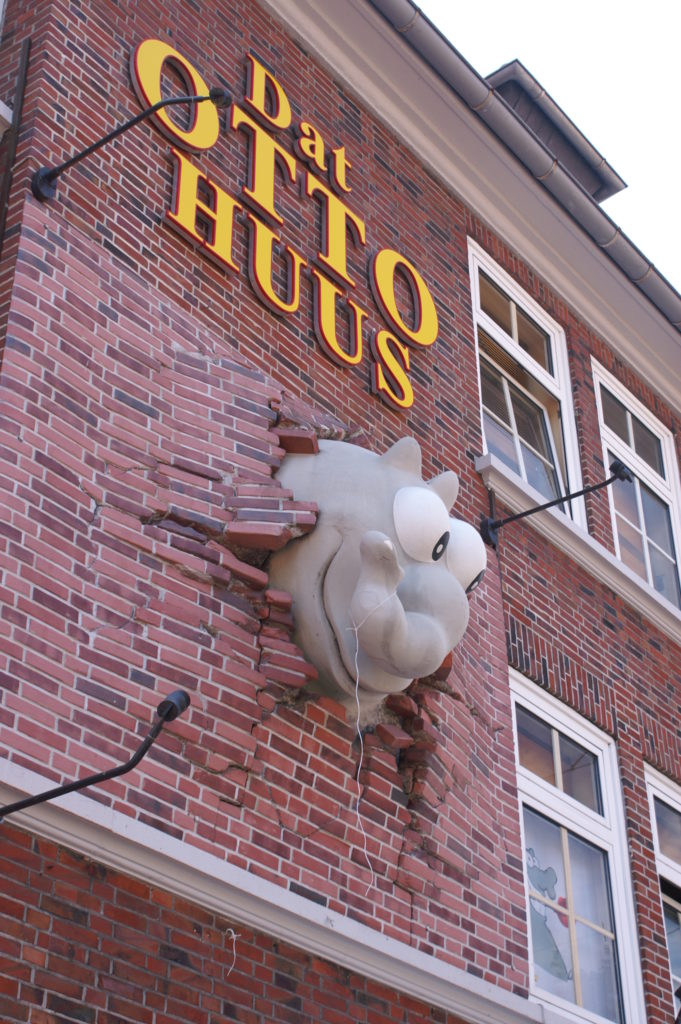 Wall of the Otto Huus with a cartoon elephant breaking through the wall