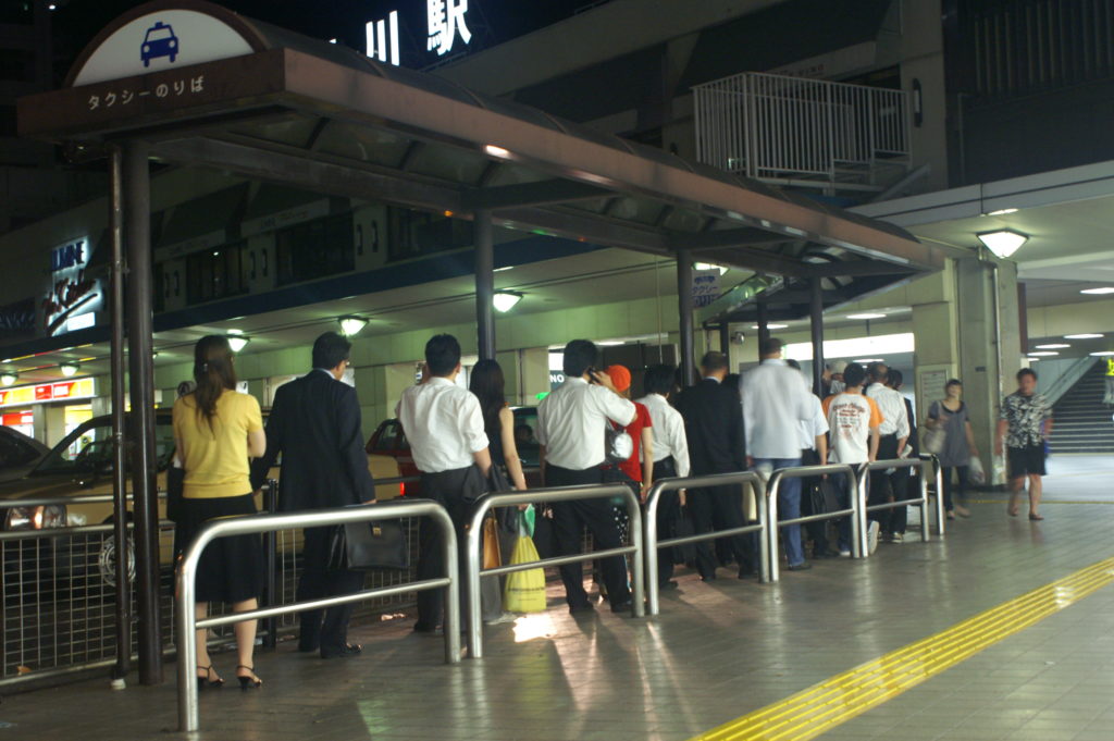 People lining up for a taxi