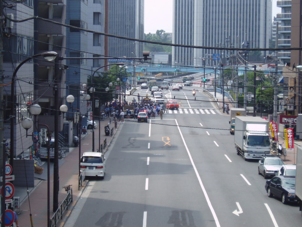 View from above: Small crowd carrying a shrine