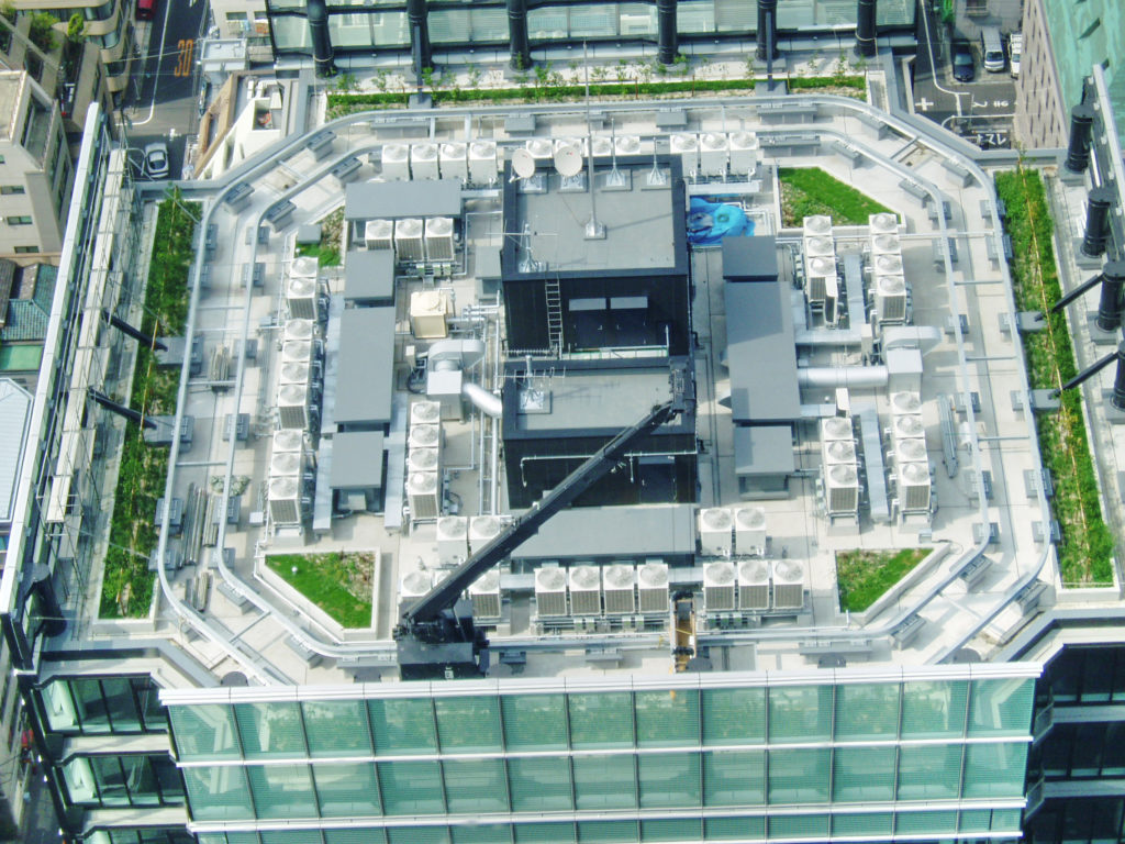 Looking at the top of another building - mostly vents but also plants