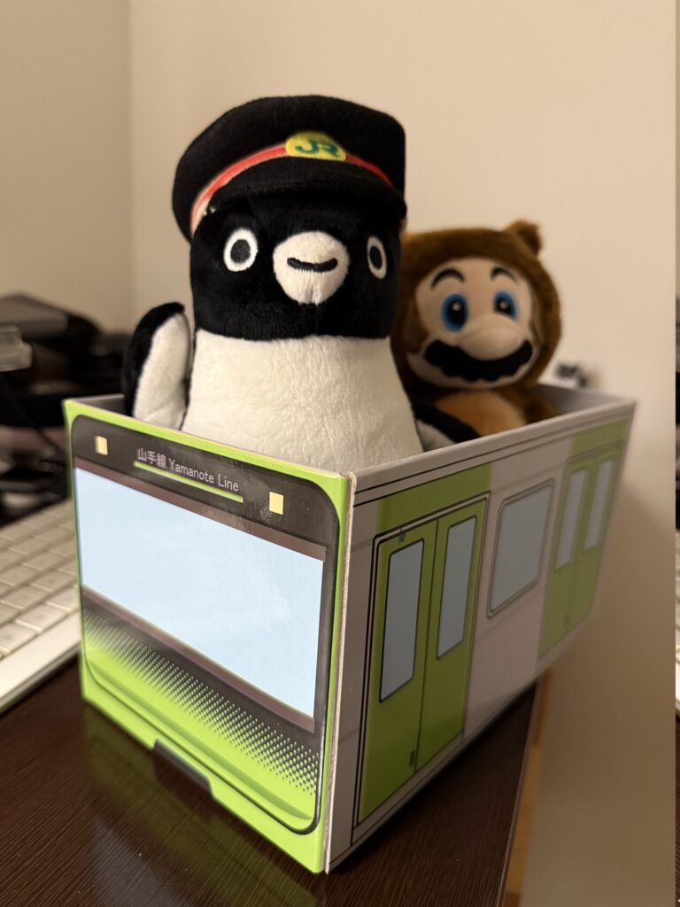 Suica penguin in a toy train